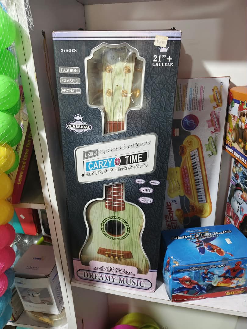 24-piece-party-favor-slime-putty-egg-pac-nbk-pty-149 Carzy Time Dreamy Music 21-Inch Acoustic Ukulele Guitar with Strap & Paddle Gift Set - Image 1